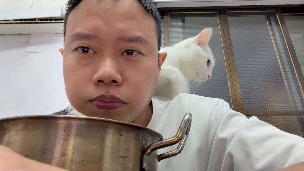 Un homme médite sur le sens de la vie en contemplant une casserole, pendant que son chat s'ennuie profondément